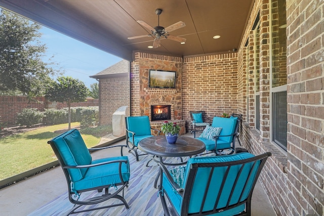 view of patio with an outdoor stone fireplace and ceiling fan