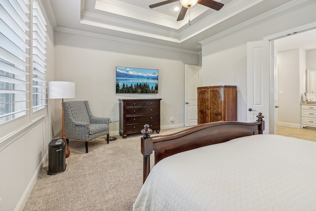 bedroom with a tray ceiling, ceiling fan, crown molding, and light colored carpet