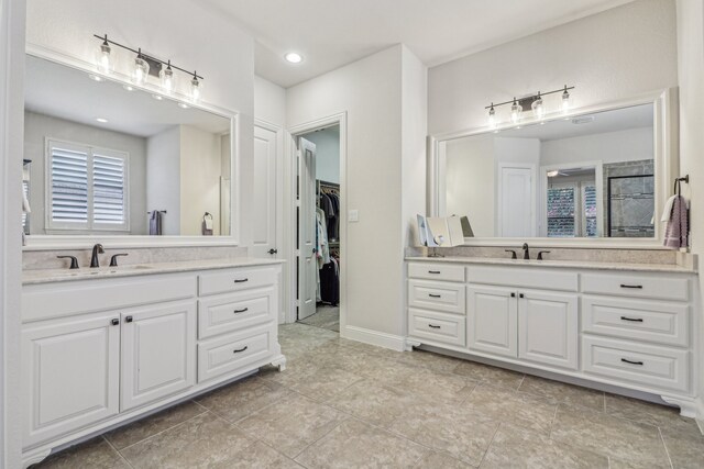 bathroom featuring tile patterned flooring and vanity