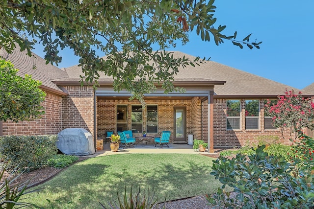 rear view of property with a patio area and a lawn