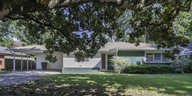 view of front of house with a front yard and a carport