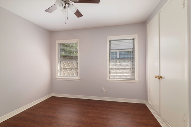 unfurnished room with dark wood-type flooring and ceiling fan