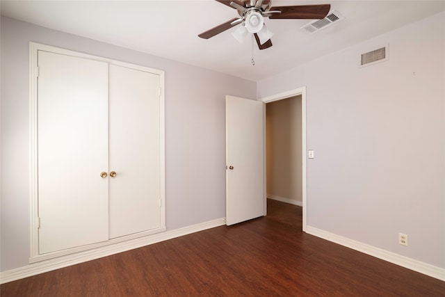 unfurnished bedroom featuring ceiling fan, a closet, and dark hardwood / wood-style floors