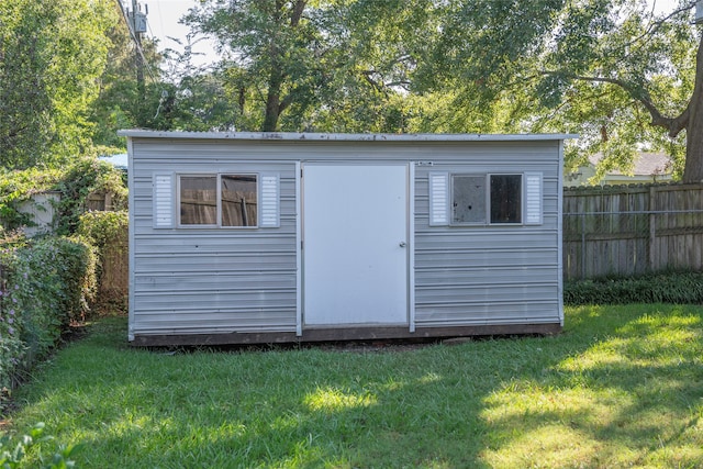 view of outbuilding with a yard