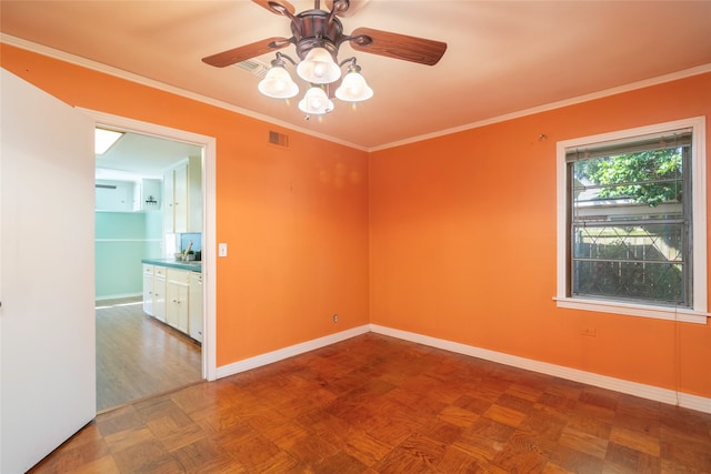 empty room with parquet flooring, ceiling fan, and crown molding