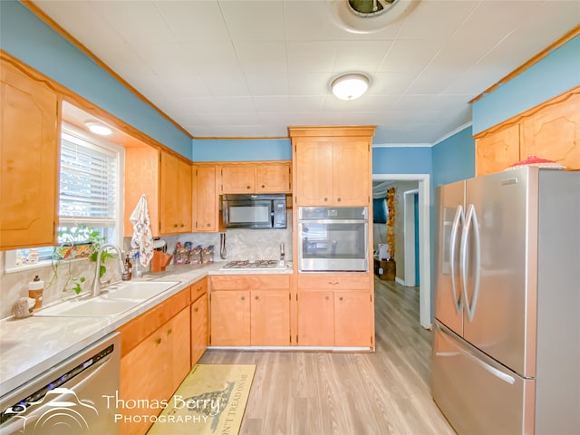 kitchen with backsplash, crown molding, sink, light hardwood / wood-style flooring, and stainless steel appliances