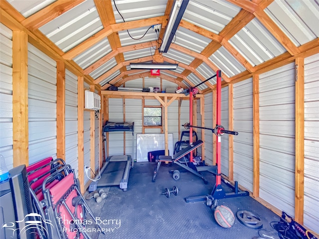 workout room with wooden walls and lofted ceiling