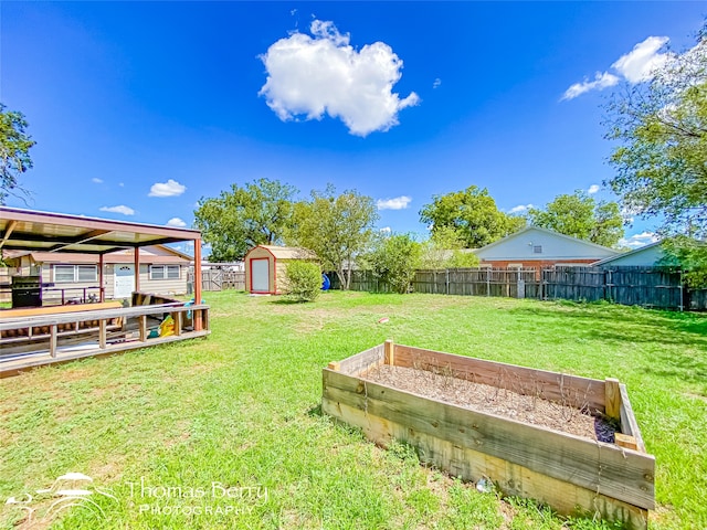 view of yard with a storage unit and a deck