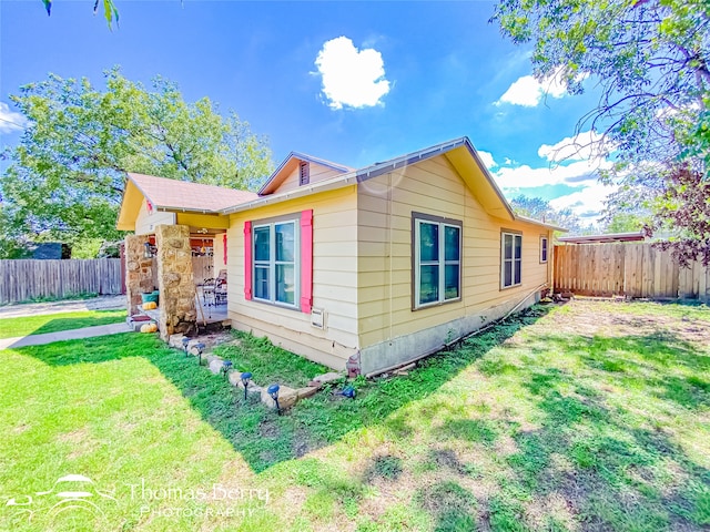 view of side of property featuring a yard