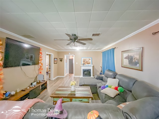 living room with crown molding, hardwood / wood-style floors, and ceiling fan