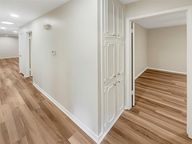 corridor with light wood-type flooring