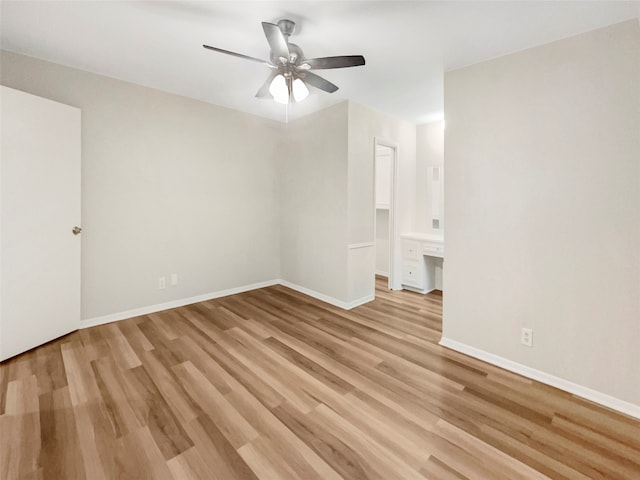 spare room with light wood-type flooring and ceiling fan