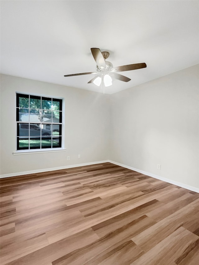 spare room with light hardwood / wood-style floors and ceiling fan