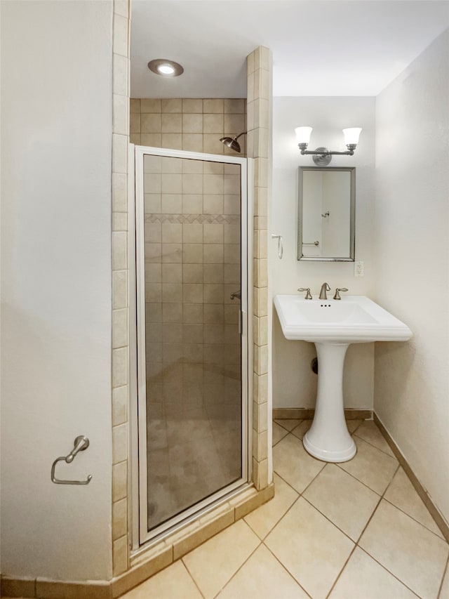 bathroom with walk in shower and tile patterned flooring