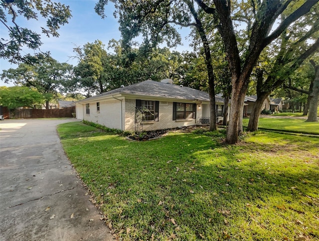 view of side of home with a yard