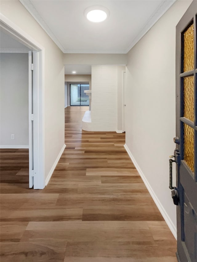 hall with crown molding and hardwood / wood-style floors