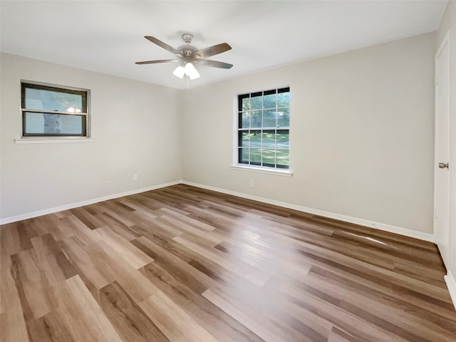 empty room featuring ceiling fan and hardwood / wood-style flooring