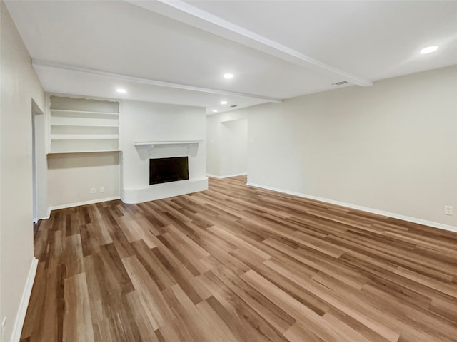 unfurnished living room featuring hardwood / wood-style flooring