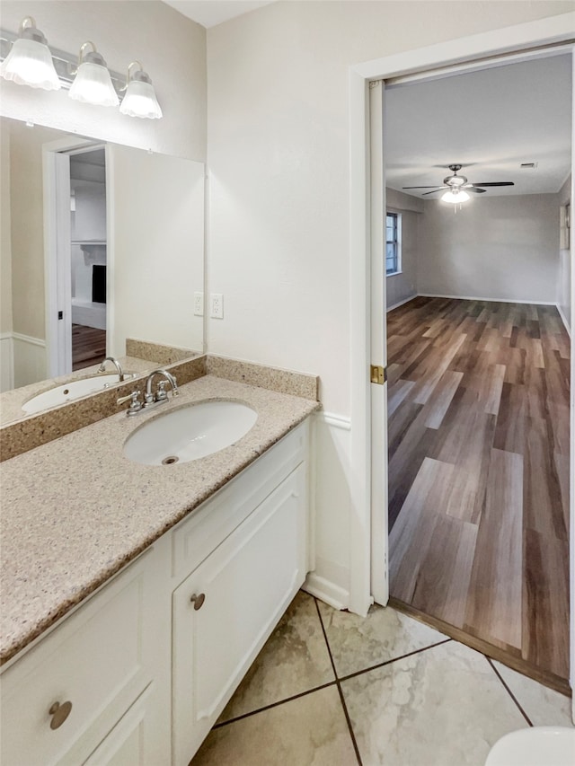 bathroom with ceiling fan, vanity, and wood-type flooring