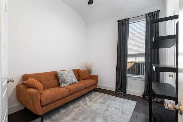 living room featuring dark hardwood / wood-style flooring and vaulted ceiling