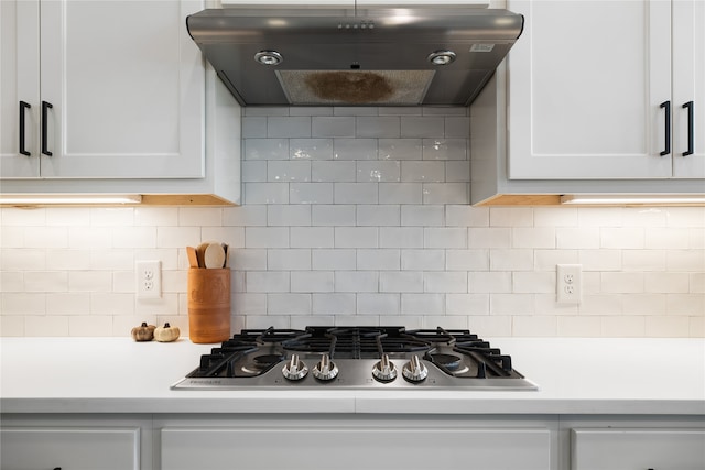 kitchen featuring backsplash, ventilation hood, white cabinetry, and stainless steel gas cooktop