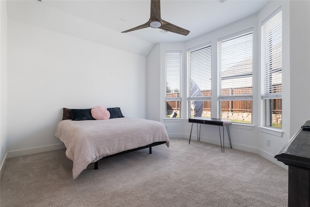 carpeted bedroom with vaulted ceiling and ceiling fan