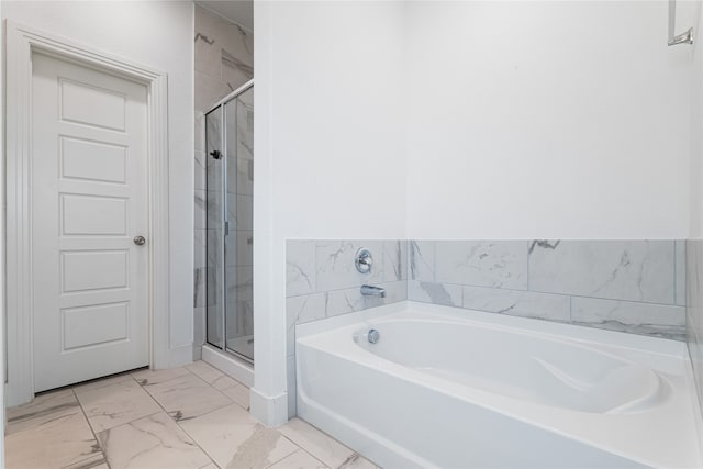 bathroom featuring independent shower and bath