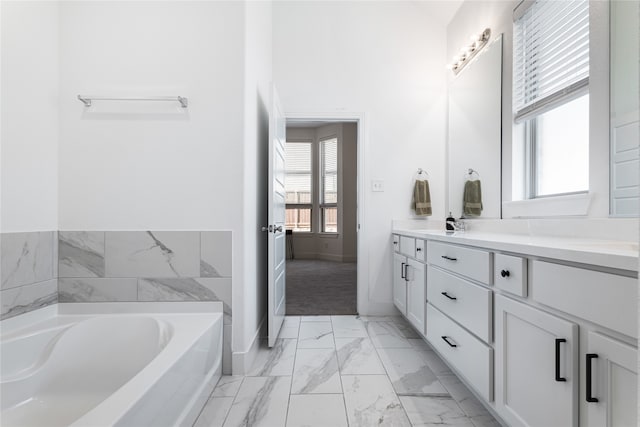 bathroom featuring vanity and a bath