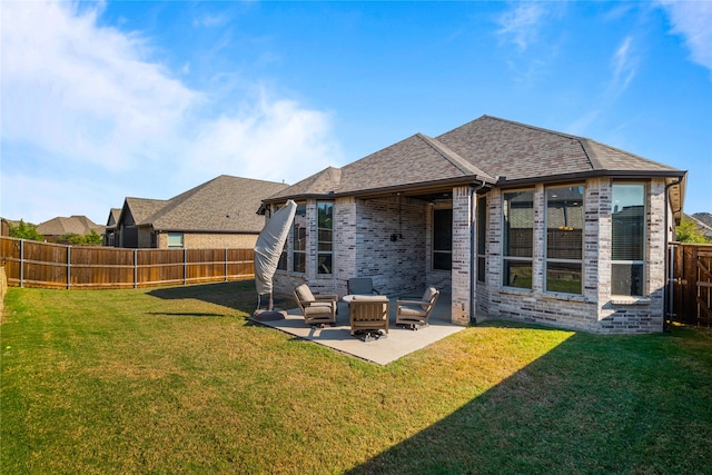 back of property with a lawn and a patio area