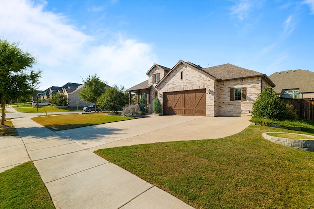 view of front of home featuring a front yard and a garage