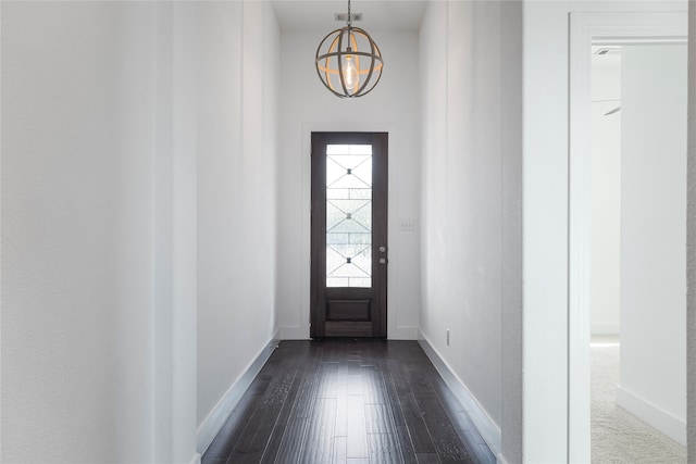 entrance foyer featuring dark hardwood / wood-style flooring and a chandelier