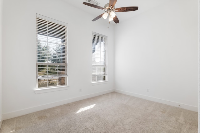 carpeted empty room featuring plenty of natural light and ceiling fan