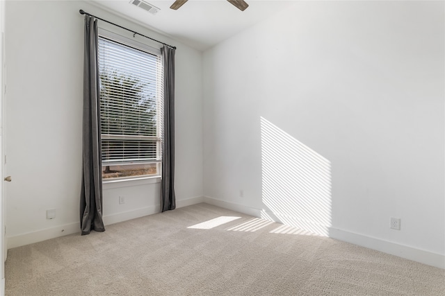 carpeted spare room with ceiling fan