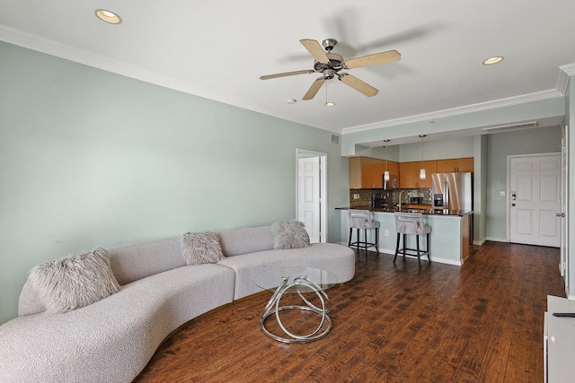 living room with ceiling fan, dark hardwood / wood-style flooring, and ornamental molding