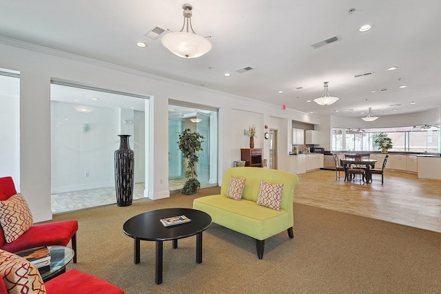 living room with light hardwood / wood-style flooring and crown molding