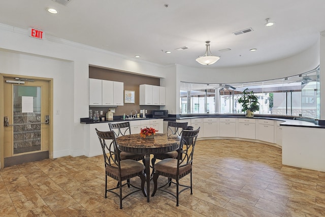 dining area featuring crown molding and sink