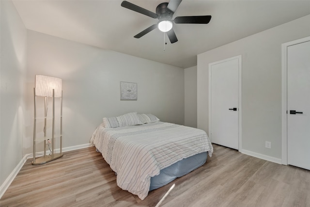 bedroom with light hardwood / wood-style flooring and ceiling fan