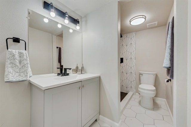 bathroom featuring a shower, vanity, toilet, and tile patterned floors