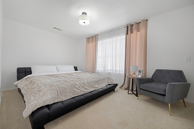 carpeted bedroom featuring a textured ceiling