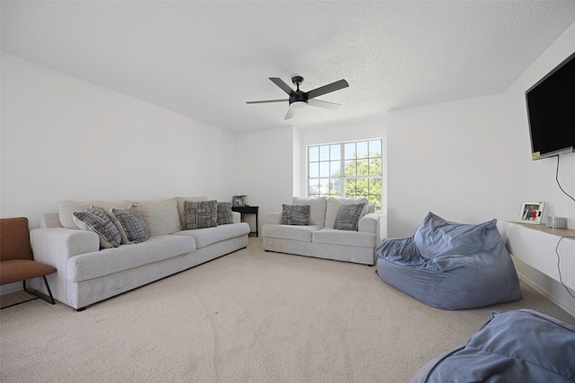 living room featuring carpet floors, a textured ceiling, and ceiling fan