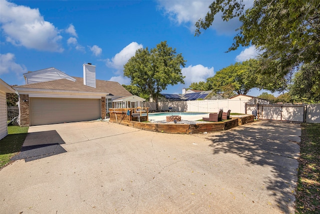 view of yard with a patio, a garage, and a fenced in pool