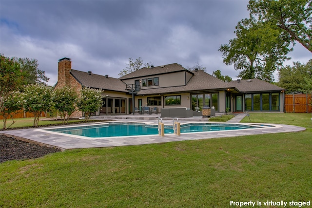 view of pool with a yard and a patio