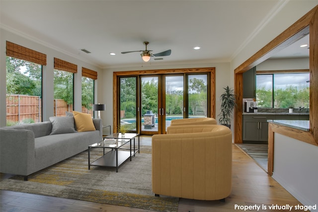 doorway featuring french doors, light hardwood / wood-style floors, and ornamental molding