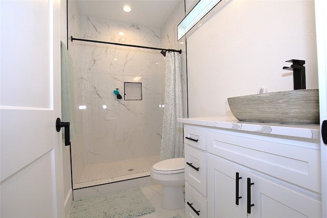 bathroom with curtained shower, vanity, and toilet