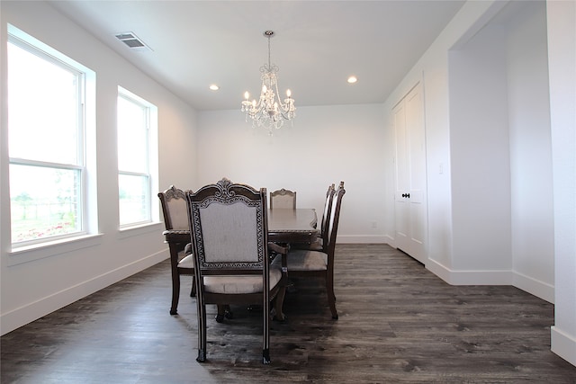 dining space with an inviting chandelier and dark wood-type flooring