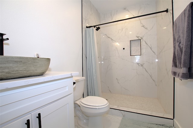 bathroom with walk in shower, vanity, and toilet