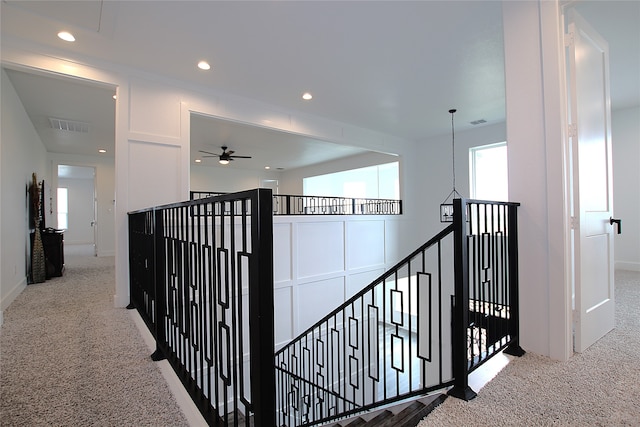 hallway featuring light colored carpet