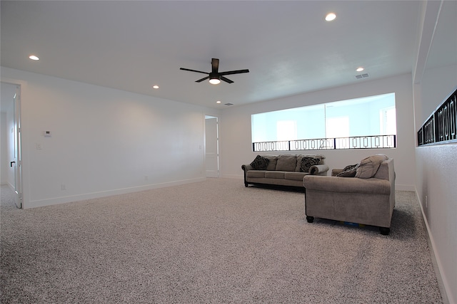 carpeted living room with ceiling fan