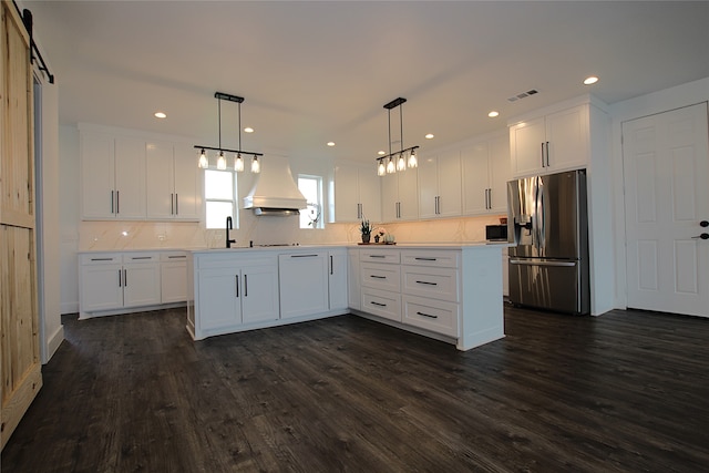 kitchen with custom range hood, white cabinetry, pendant lighting, stainless steel appliances, and dark hardwood / wood-style floors