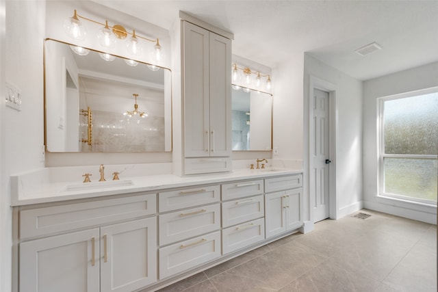 bathroom with vanity, a notable chandelier, and tile patterned floors